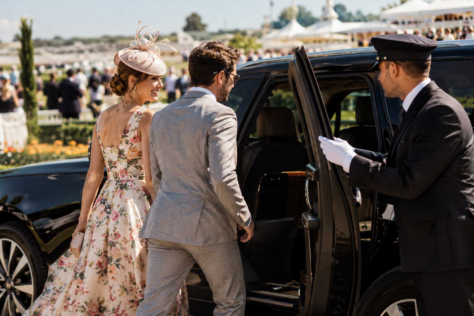 Race-day guests stepping into a chauffeur-driven SUV outside a racecourse